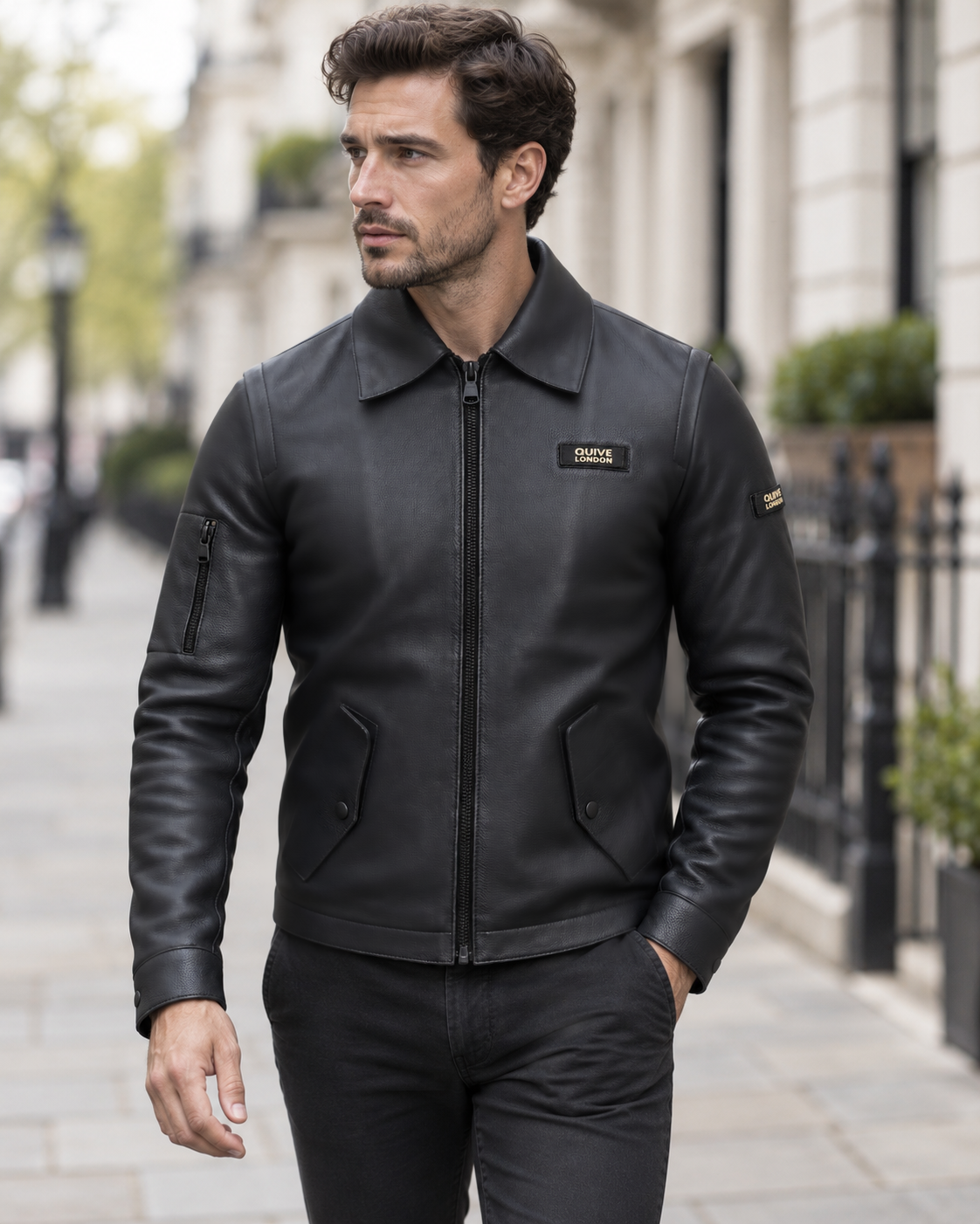 Male model wearing the SLOANE black leather utility jacket on a softly blurred London street