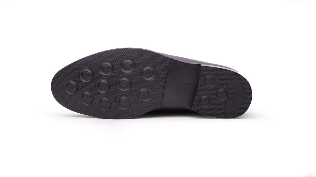 Outsole view of QUIVE London Ventor black leather penny loafer