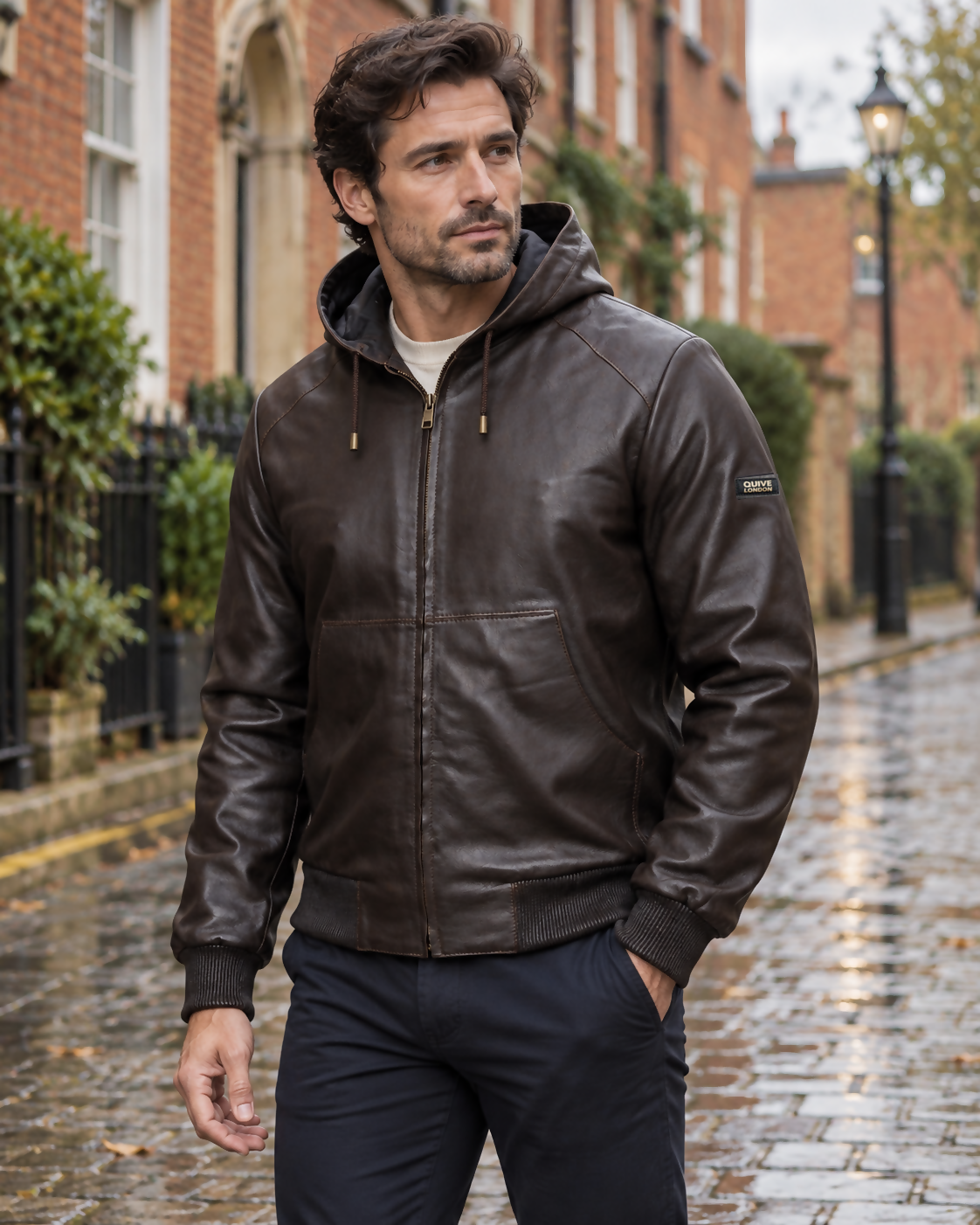 Man wearing the brown KNIGHTSBRIDGE hooded leather jacket on a softly blurred British street
