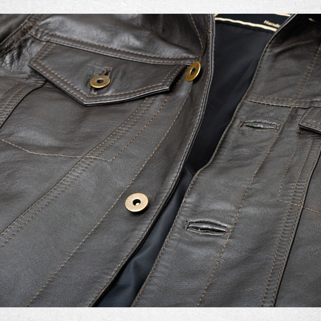 Brown BELGRAVE leather jacket close-up showing chest pocket and button detailing