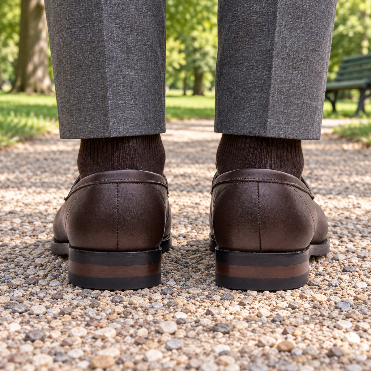 Rear view of ALBANY brown calf leather penny loafers in a park