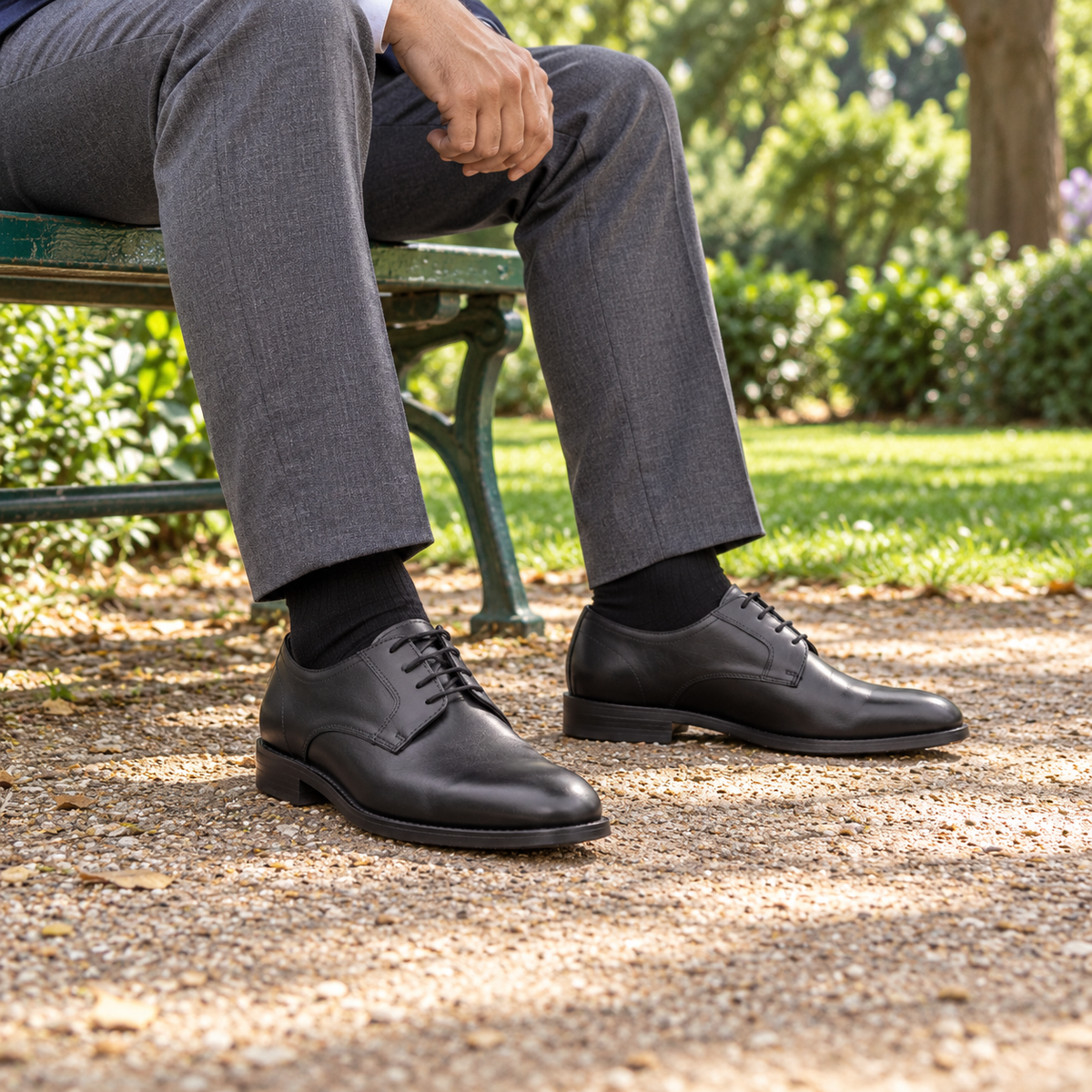 GROSVENOR black calf leather Derby shoes worn with grey trousers in a park