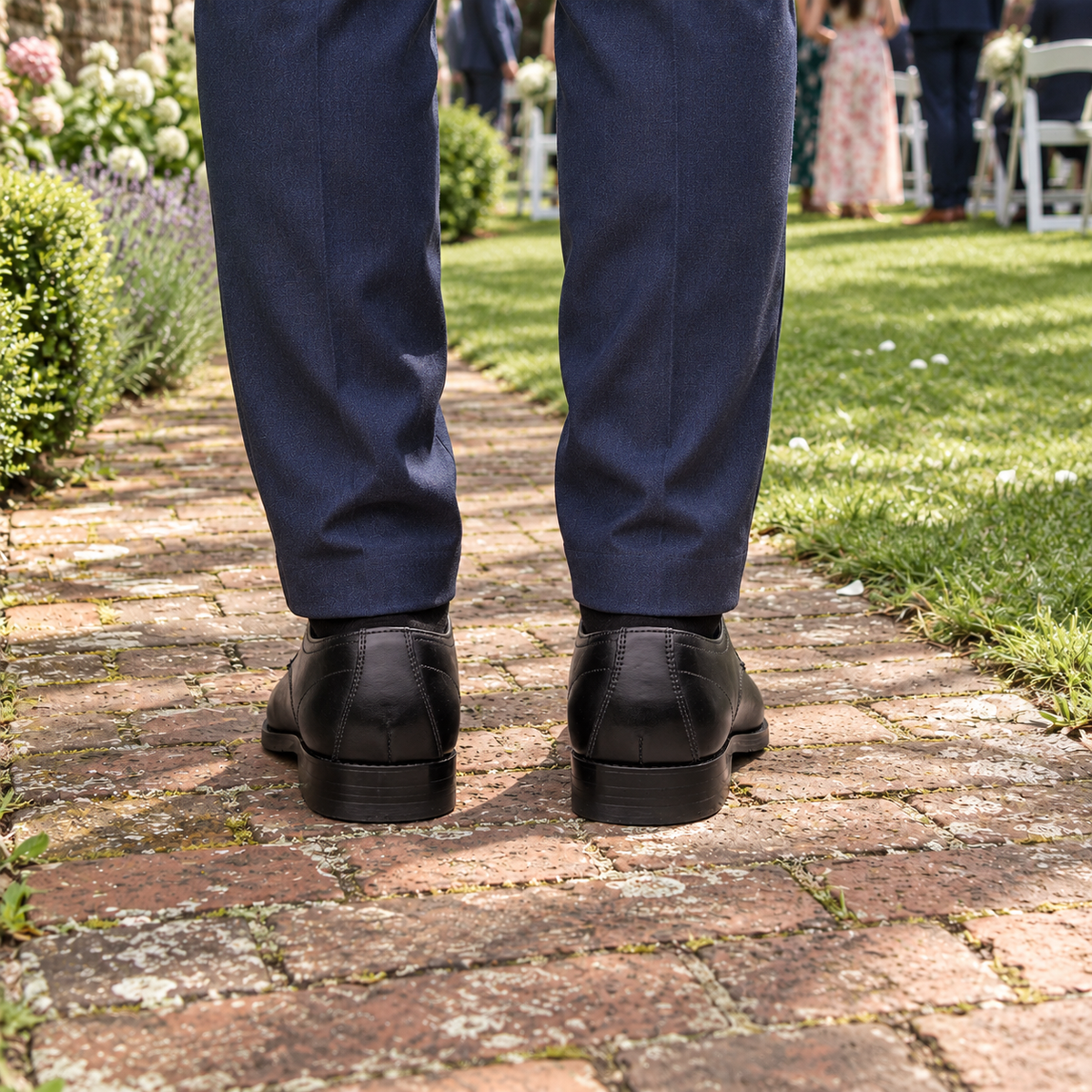Rear view of GROSVENOR black calf leather Derby shoes at a garden wedding, showing heel stitching