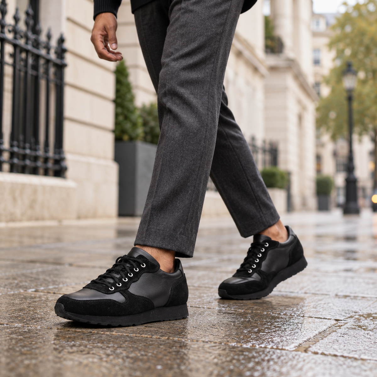 Model wearing black QUIVE London BELGRAVIA leather and suede trainers on a London street