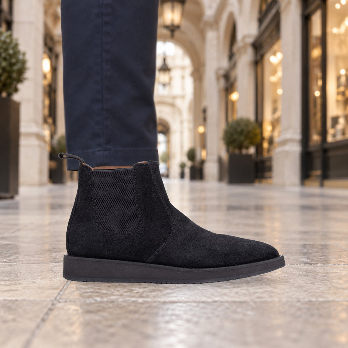 Model wearing black QUIVE London MAYFAIR suede Chelsea boots on a London street