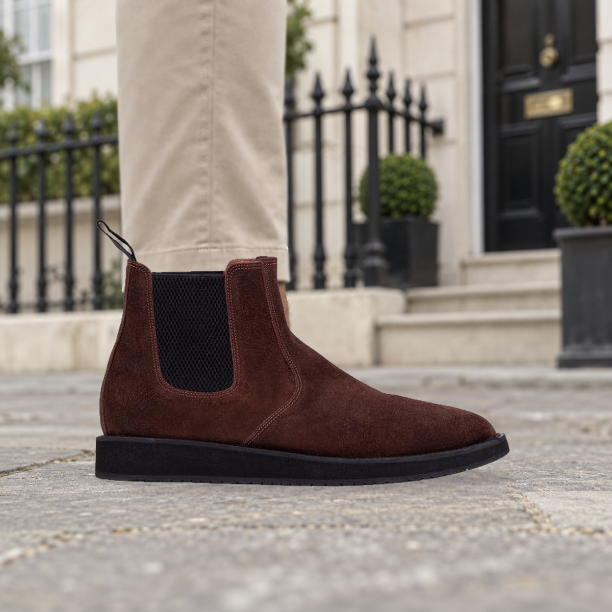 Model wearing brown QUIVE London MAYFAIR suede Chelsea boots outside a London townhouse