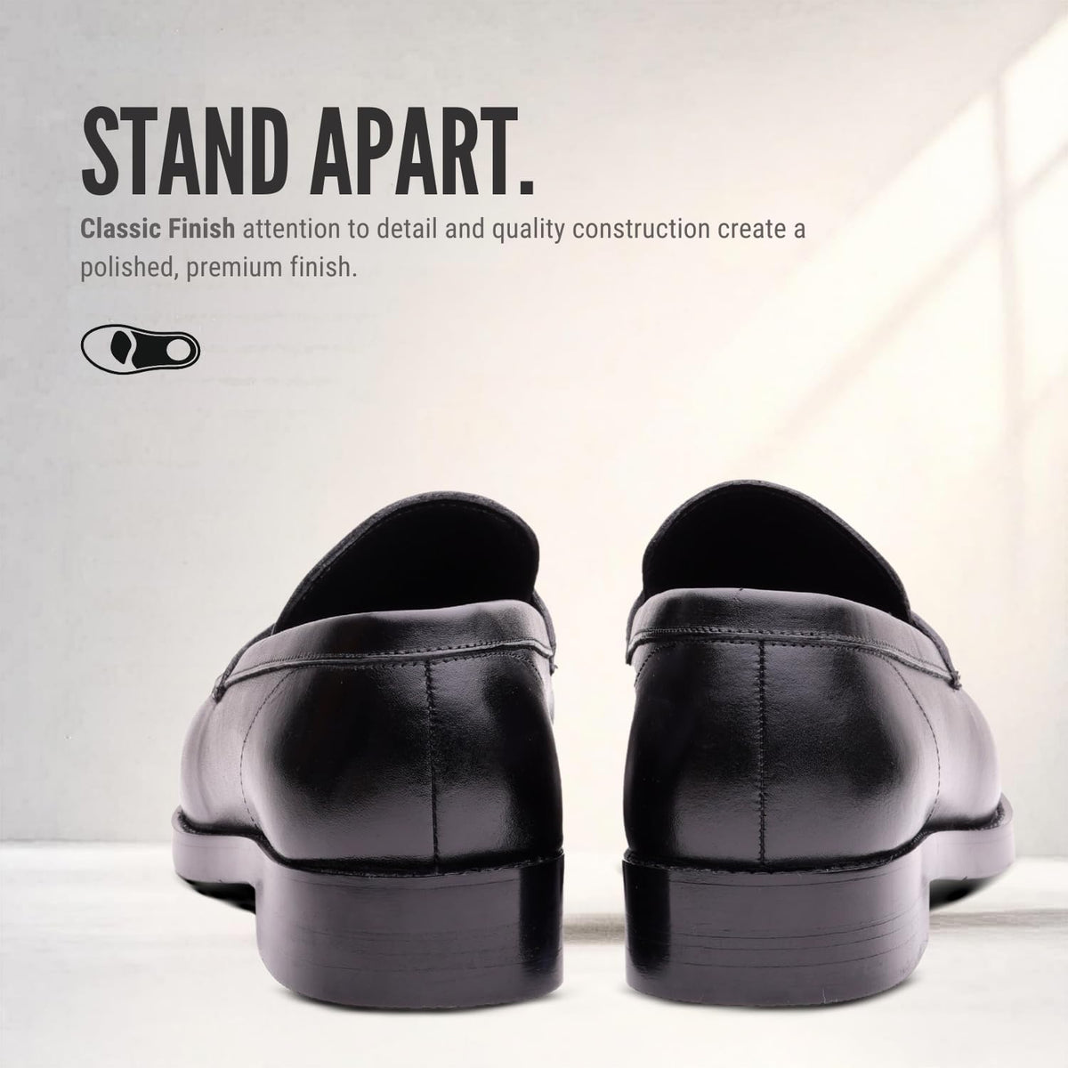 Heel view of REGENT black leather penny loafers