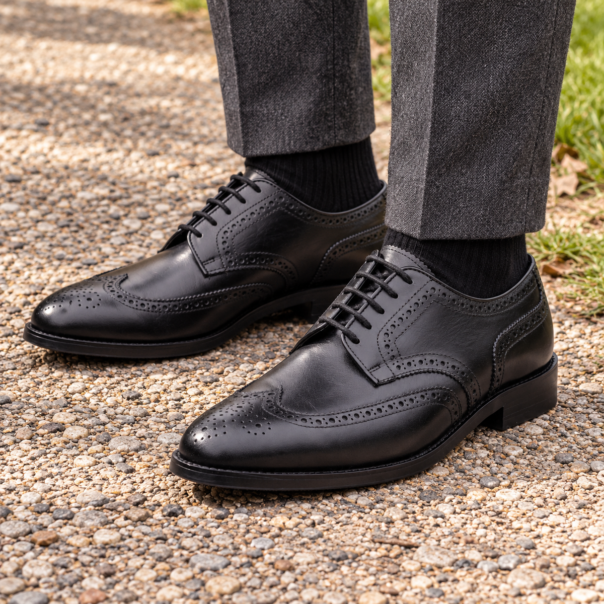 WESTMINSTER black calf leather Derby shoes showing wingtip brogue detailing on a park path