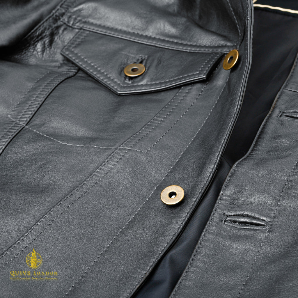 Black BELGRAVE leather jacket close-up showing flap pocket and leather panel stitching
