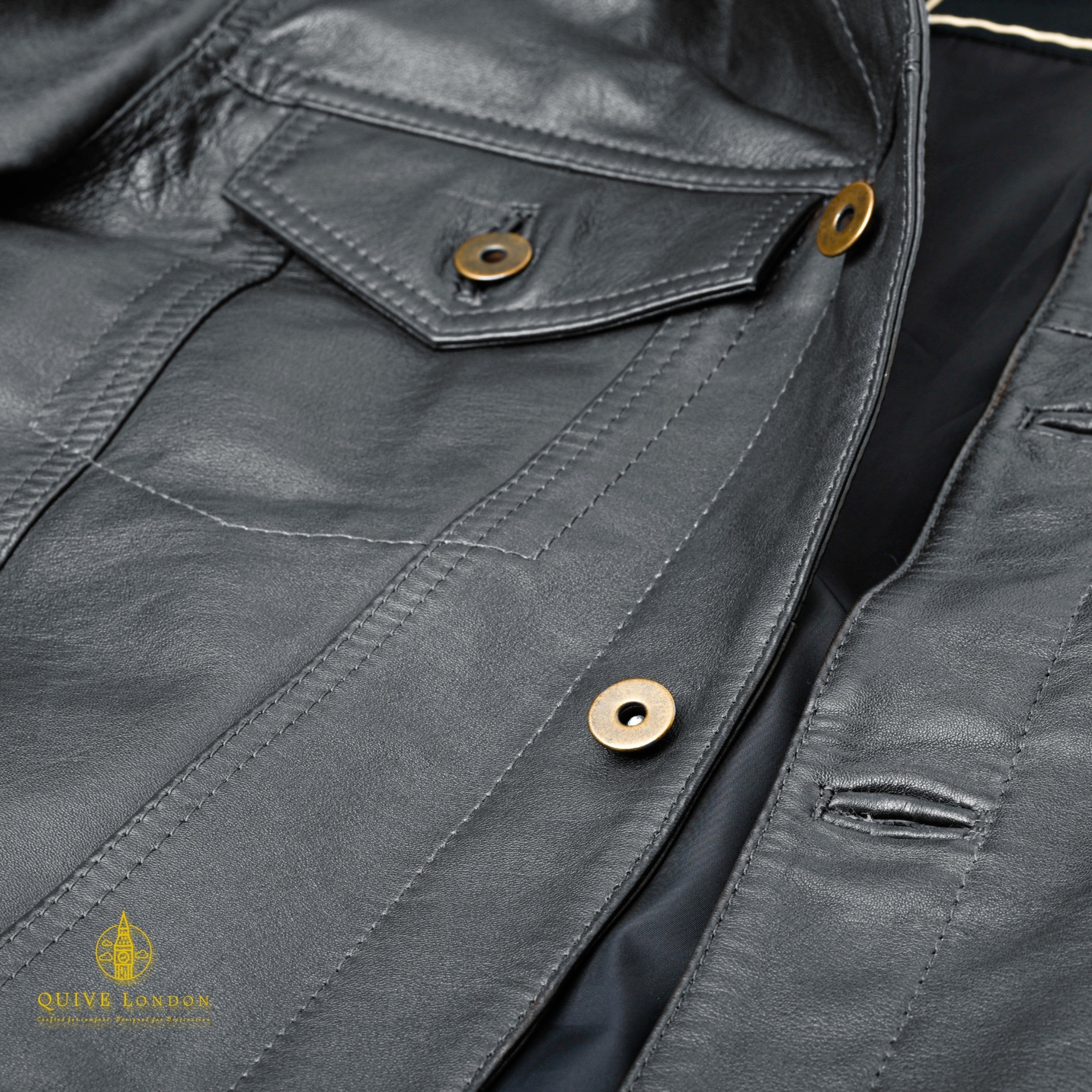 Black BELGRAVE leather jacket close-up showing flap pocket and leather panel stitching